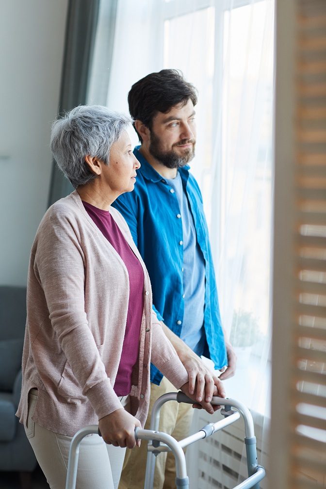 Caregiver and woman staring out the window